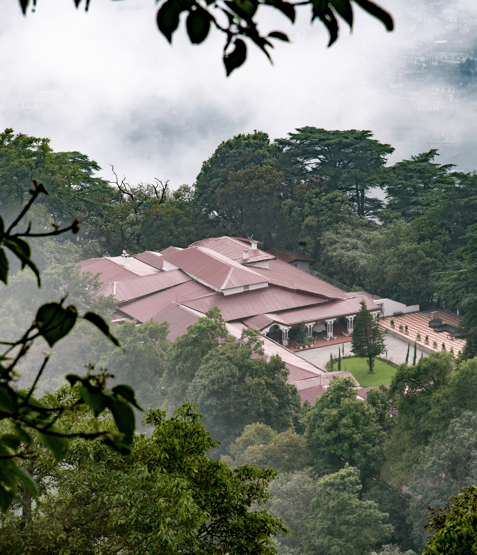 Facade of the The Claridges Nabha Residence in Mussoorie during a foggy day - Claridges Collection
