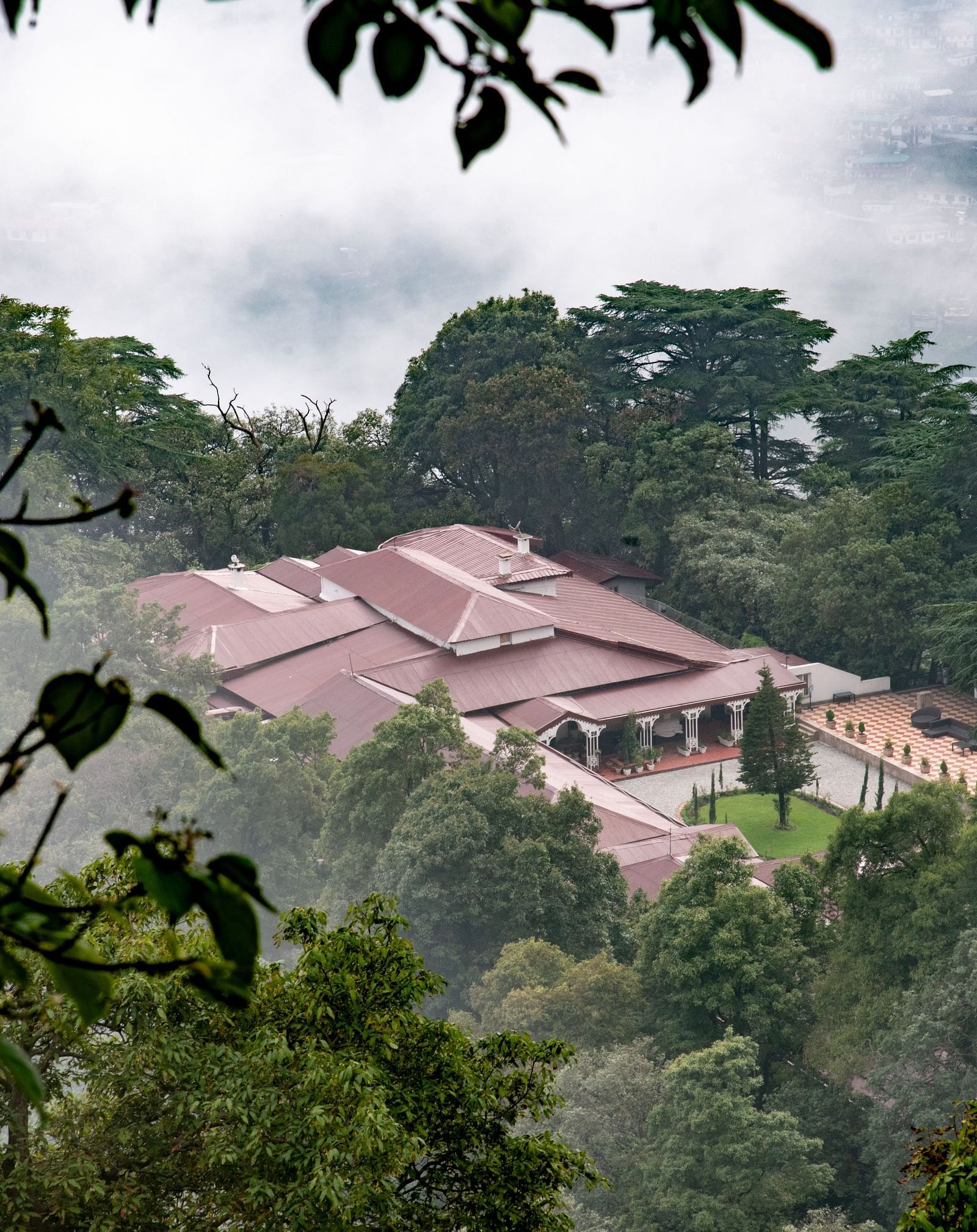 Facade of the The Claridges Nabha Residence in Mussoorie during a foggy day - Claridges Collection