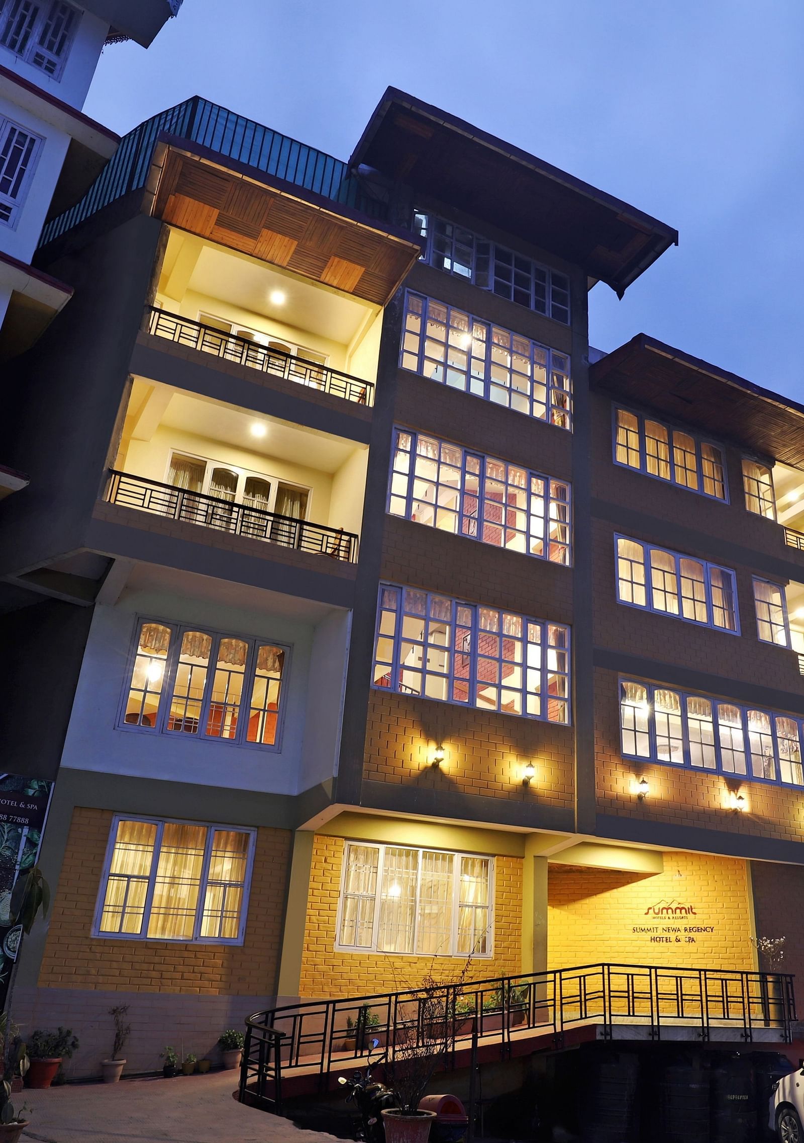 A low-high angle of a well-lit facade of Summit Newa Regency & Spa, Pelling