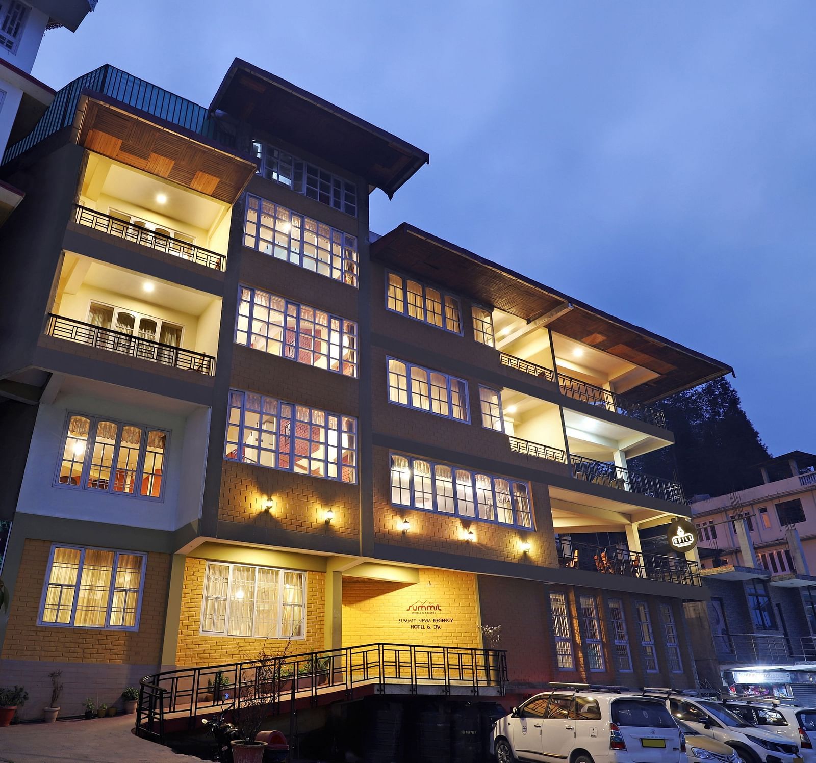 A low-high angle of a well-lit facade of Summit Newa Regency & Spa, Pelling
