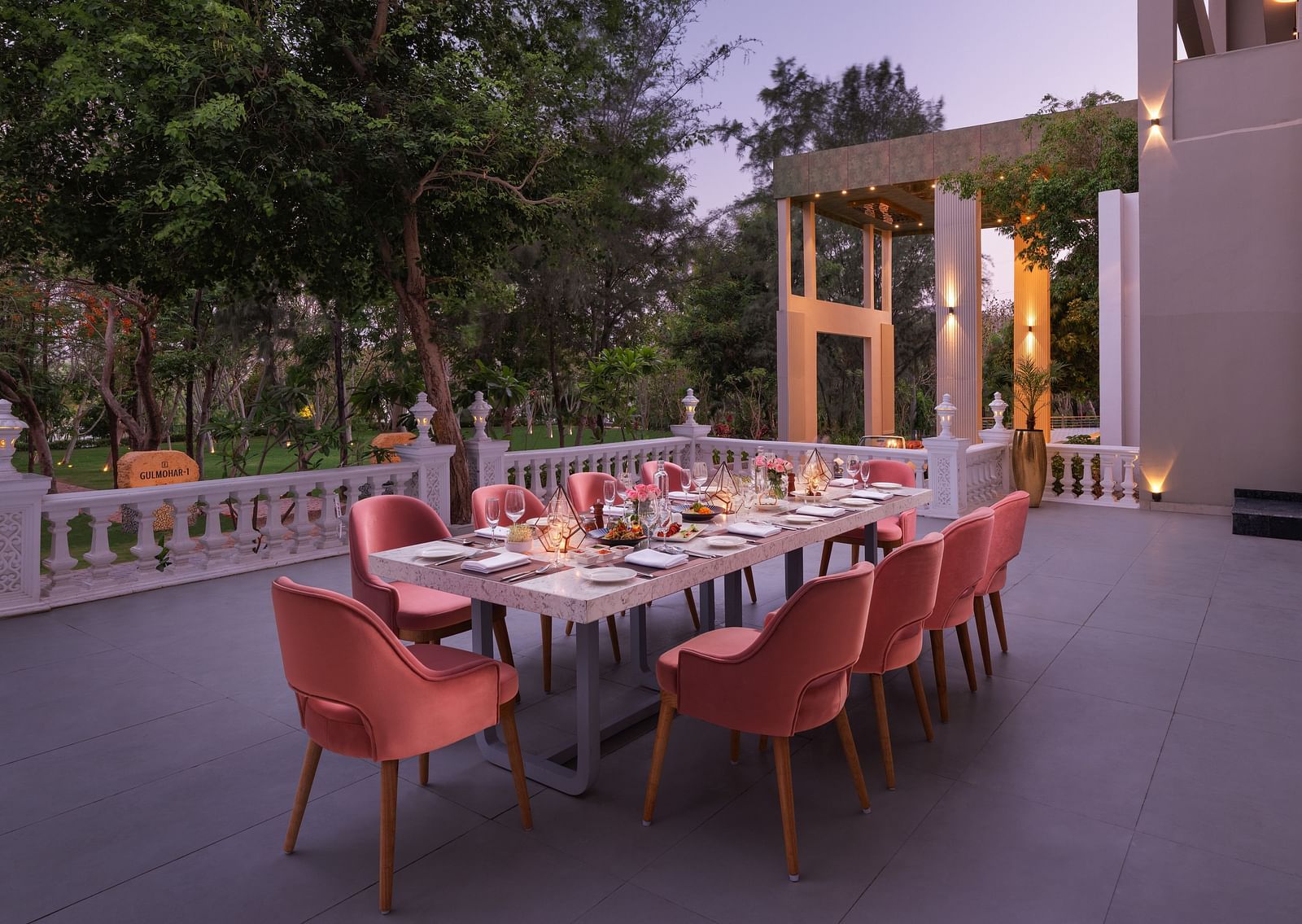 An elegant dining setting placed outdoors at Essentia Luxury Resort & Spa, Udaipur. 