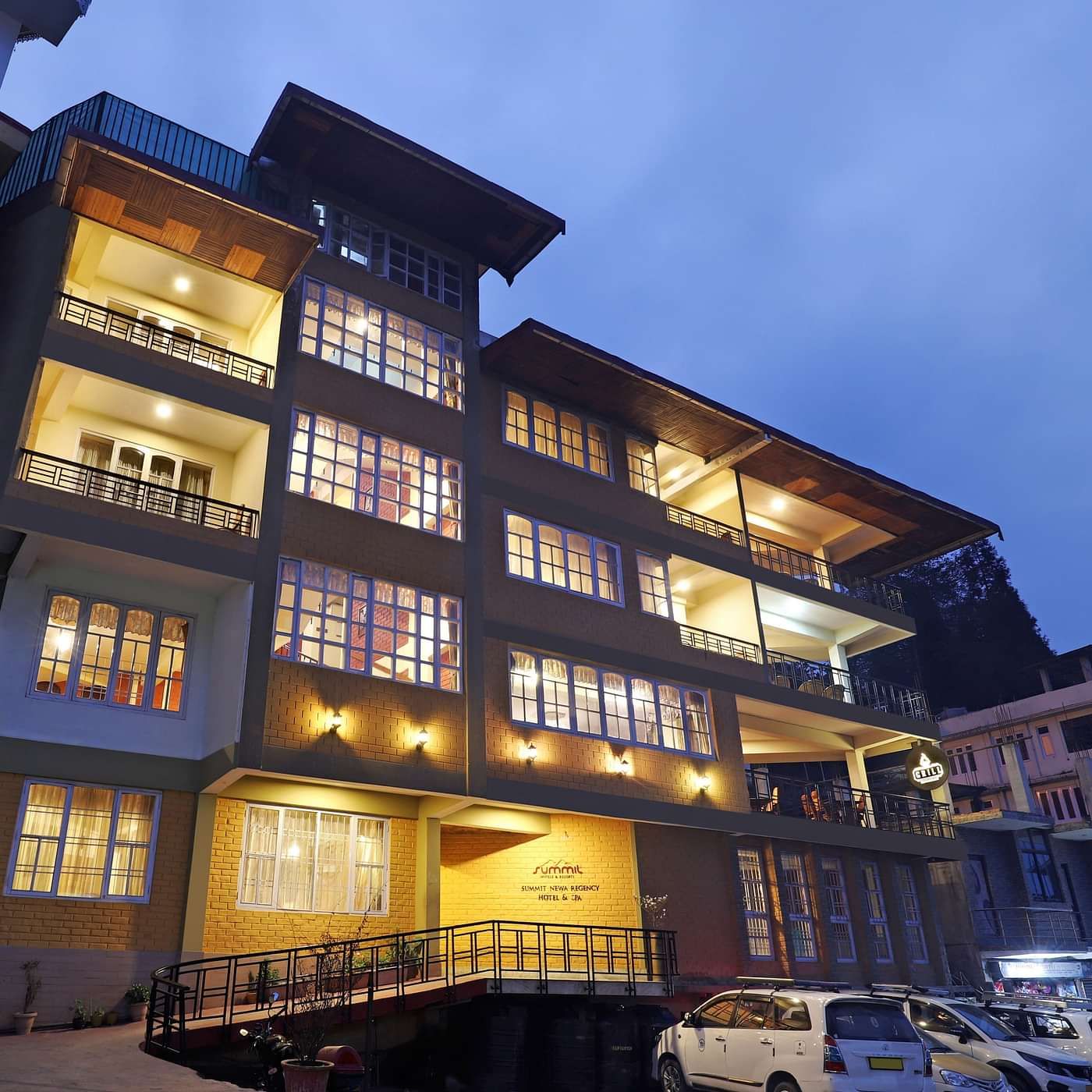A low-high angle of a well-lit facade of Summit Newa Regency & Spa, Pelling