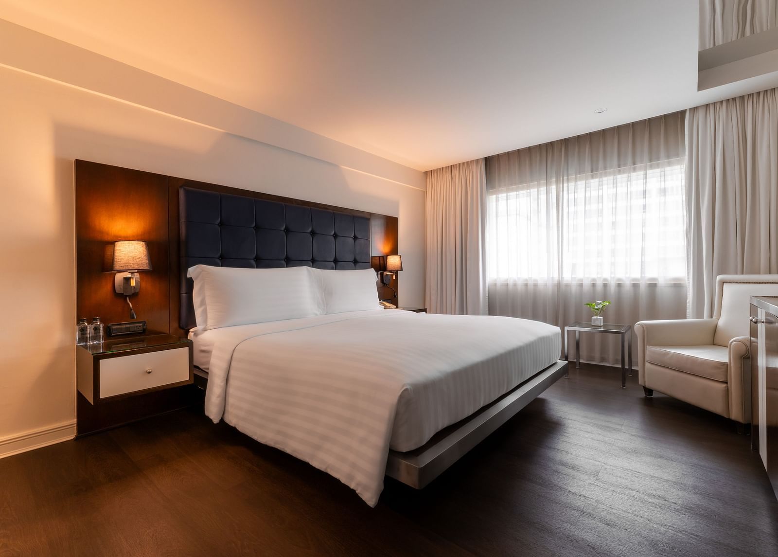 An overview of a double bed with side tables and lamps - Night Hotel Bangkok.