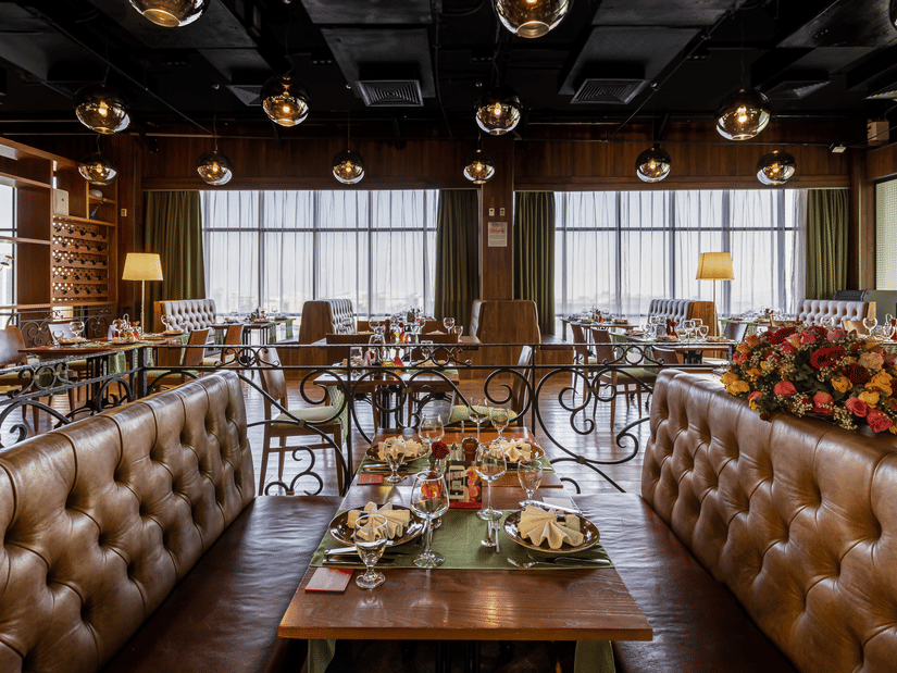 An overview of the sofa seating with a table in the centre having many items on it inside FOGO NO CHÃO restaurant - Ramada by Wyndham Addis, Addis Ababa
