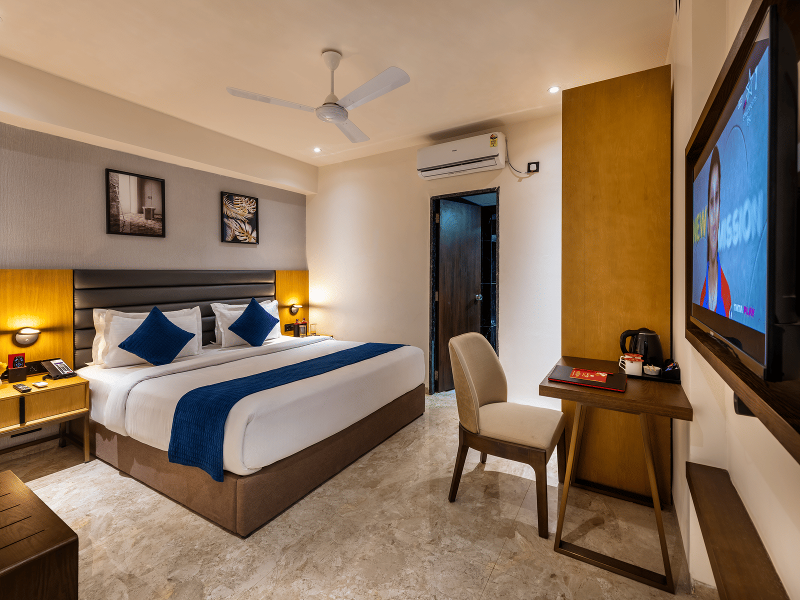 Elegant reception area with decorative wall art and welcoming front desk at Lords Studio Inn, Jamnagar.