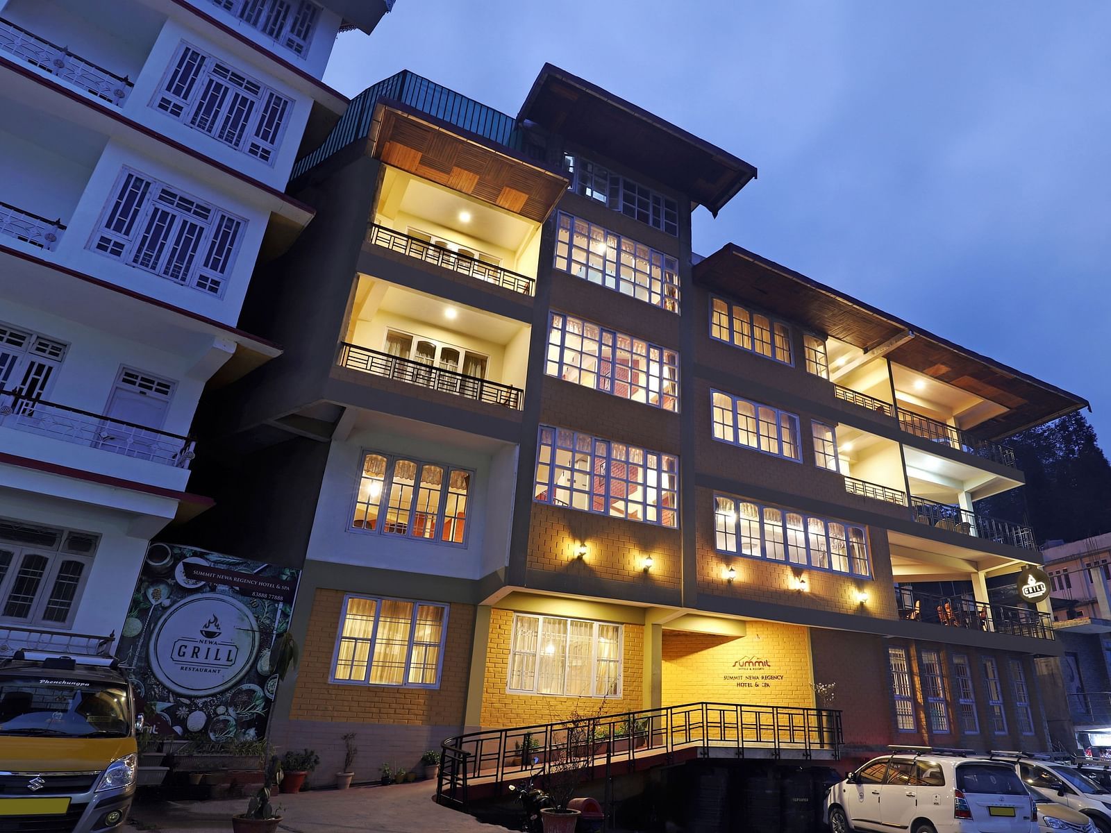 A low-high angle of a well-lit facade of Summit Newa Regency & Spa, Pelling