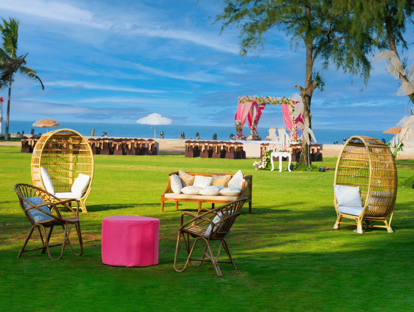 A cosy outdoor lounge seating arranged on the lawn overlooking a beachfront wedding mandap in Mahabalipuram - Grande Bay Resort & Spa, Mamallapuram