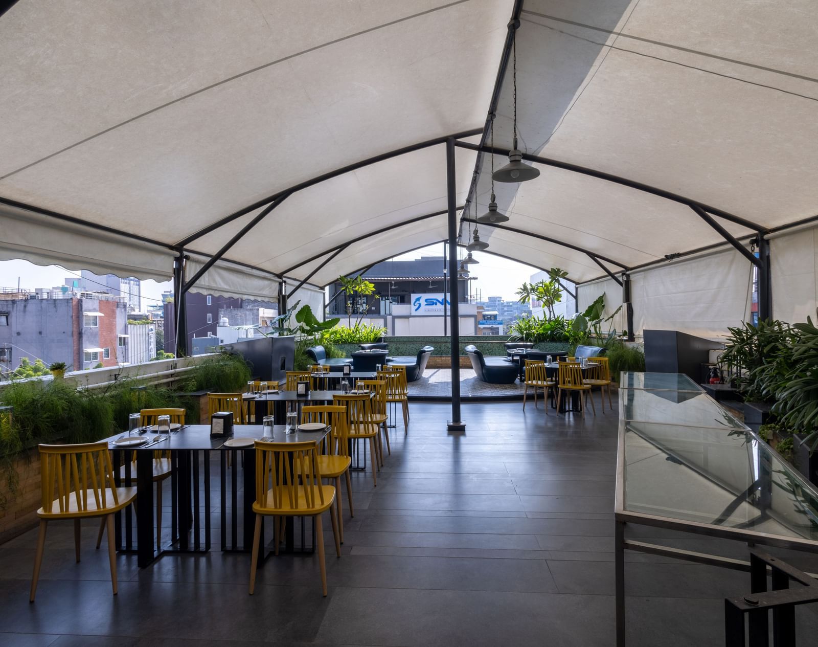 Rooftop dining setup in the Pravasa Cafe at Pravasa Stay Vijay Nagar, Indore.
