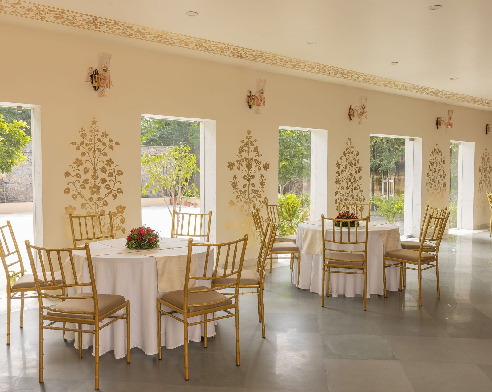 Another view of a banquet hall with set tables and chairs inside Royal Heritage Haveli.