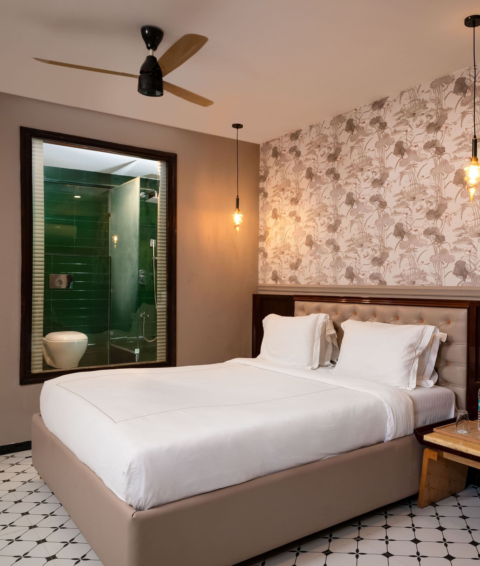 A portrait image showing a well-furnished room with contemporary décor and comfortable furnishings at Crescent Resort, Goa