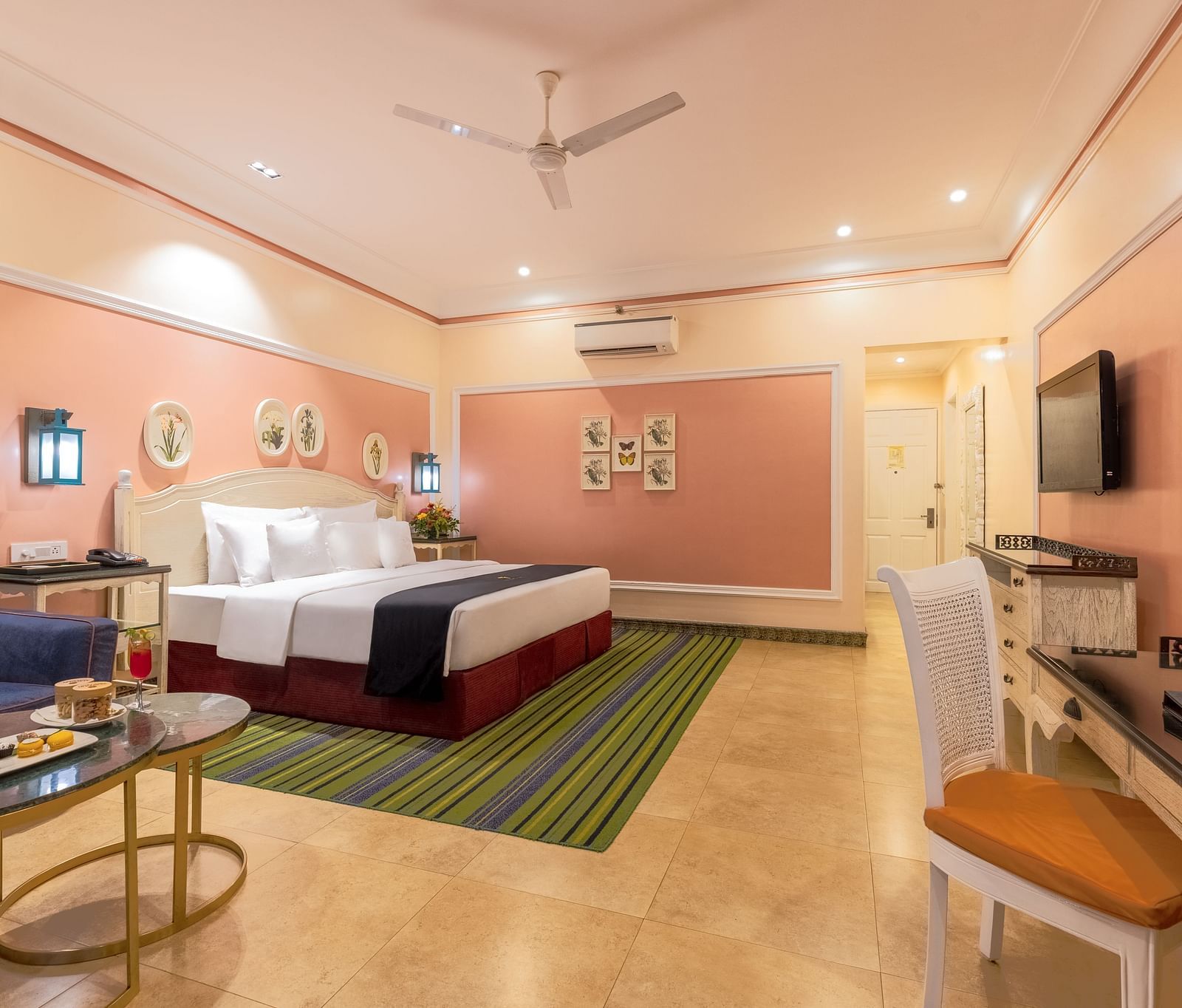 Spacious room with large bed, a seating area, a workstation, and a wall-mounted TV at MAYFAIR Palm Beach Resort, Gopalpur-On-Sea