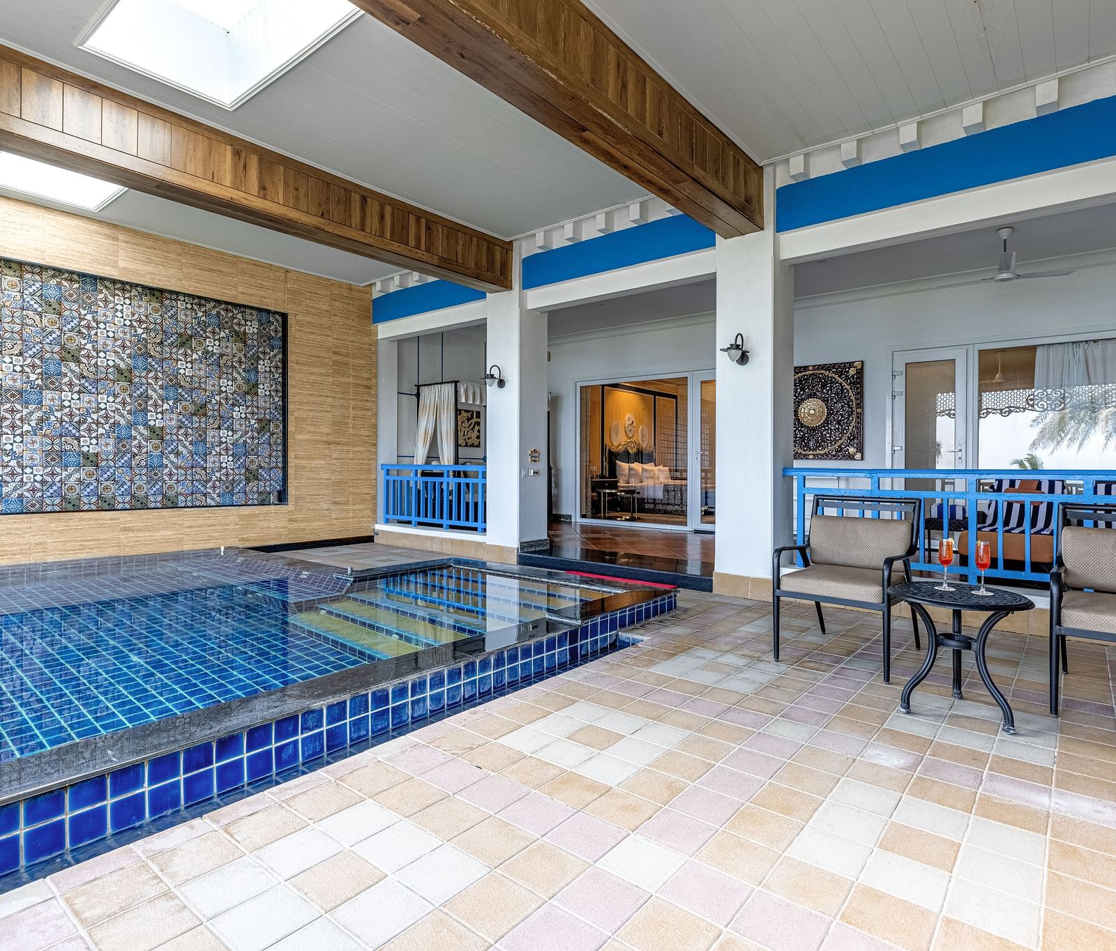 Pool area with a seating area, with the view of room with large bed at MAYFAIR Palm Beach Resort, Gopalpur-On-Sea