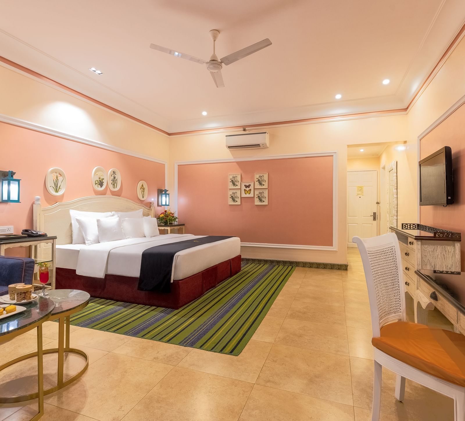 Spacious room with large bed, a seating area, a workstation, and a wall-mounted TV at MAYFAIR Palm Beach Resort, Gopalpur-On-Sea