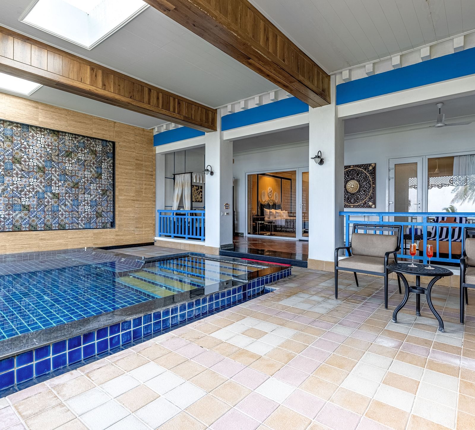Pool area with a seating area, with the view of room with large bed at MAYFAIR Palm Beach Resort, Gopalpur-On-Sea