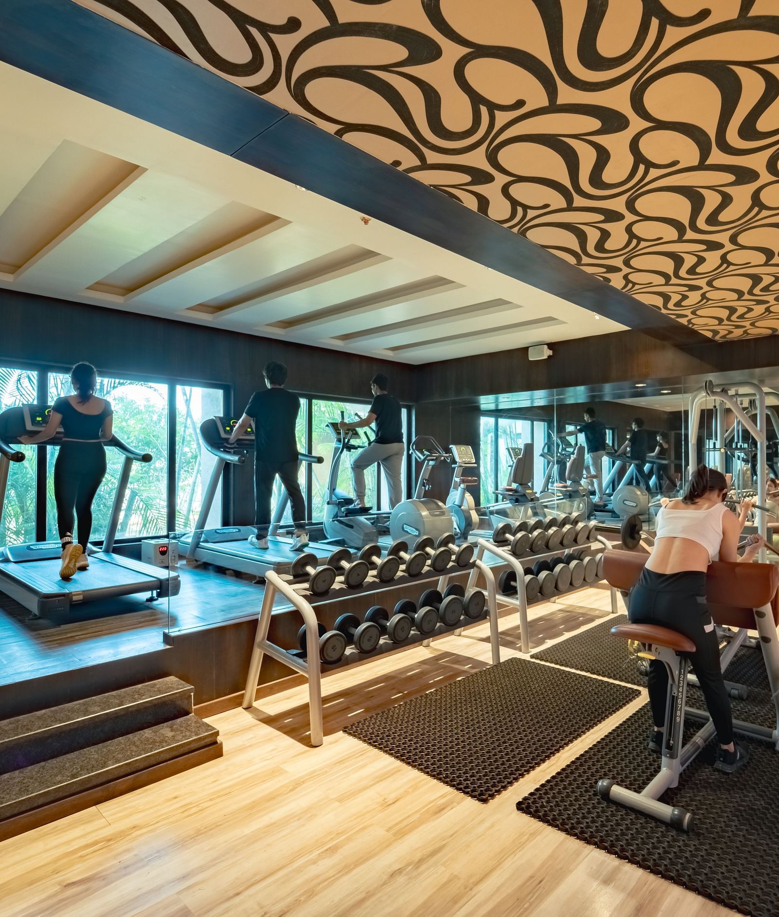 Individuals exercising in the spacious gym at Crescent Spa & Resort, Indore