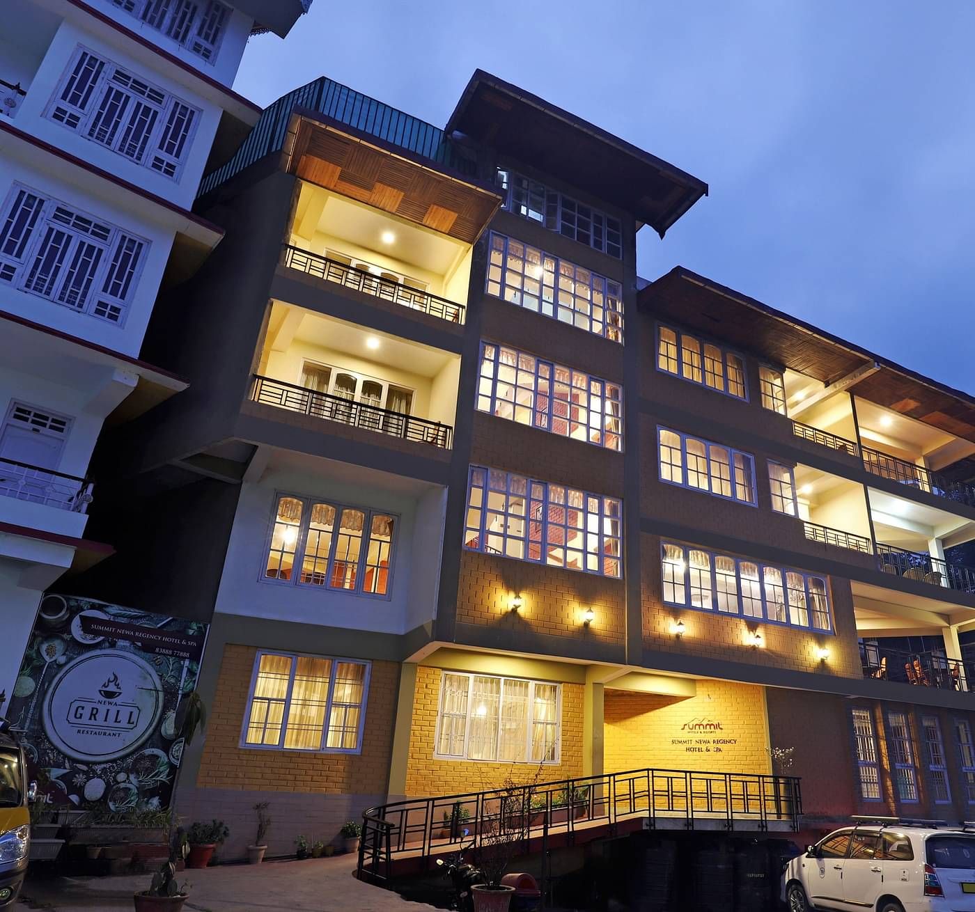 A low-high angle of a well-lit facade of Summit Newa Regency & Spa, Pelling