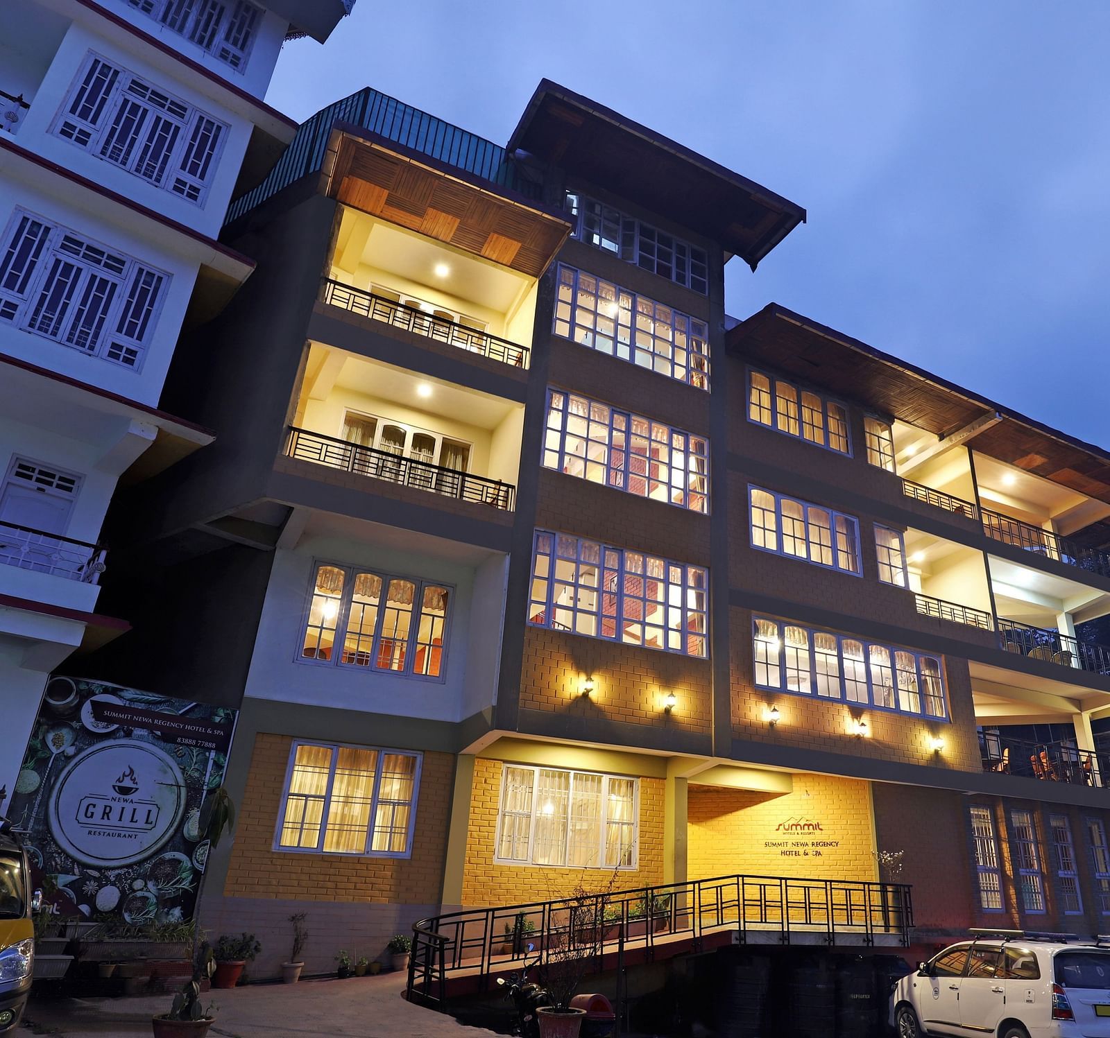 A low-high angle of a well-lit facade of Summit Newa Regency & Spa, Pelling