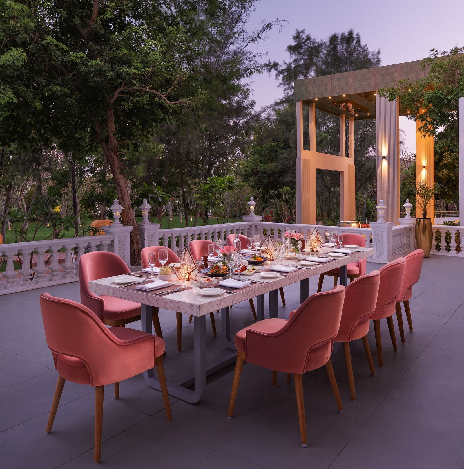 An elegant dining setting placed outdoors at Essentia Luxury Resort & Spa, Udaipur. 