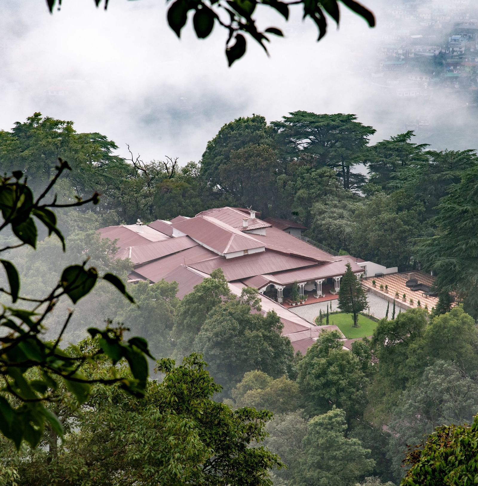 Facade of the The Claridges Nabha Residence in Mussoorie during a foggy day - Claridges Collection