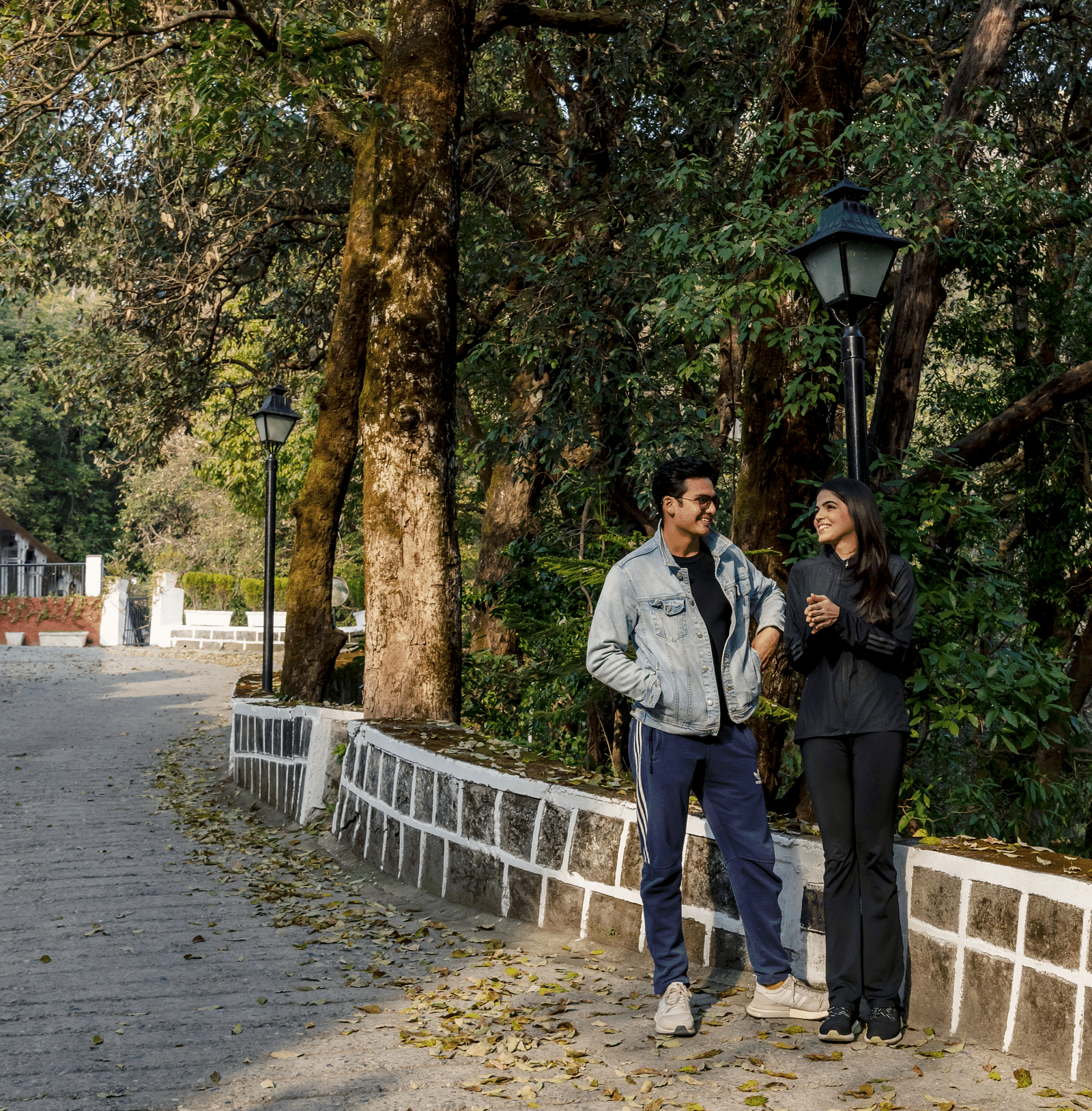 a couple having a conversation with a forest in the background