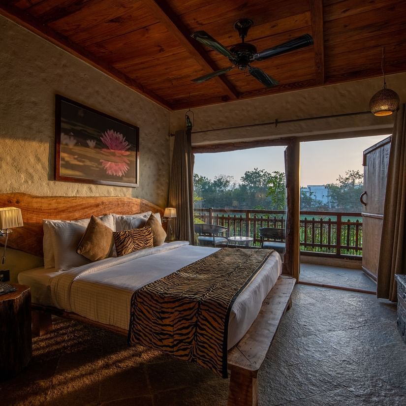 view of the bed beside the balcony offered by one of the rooms in Ranthambore