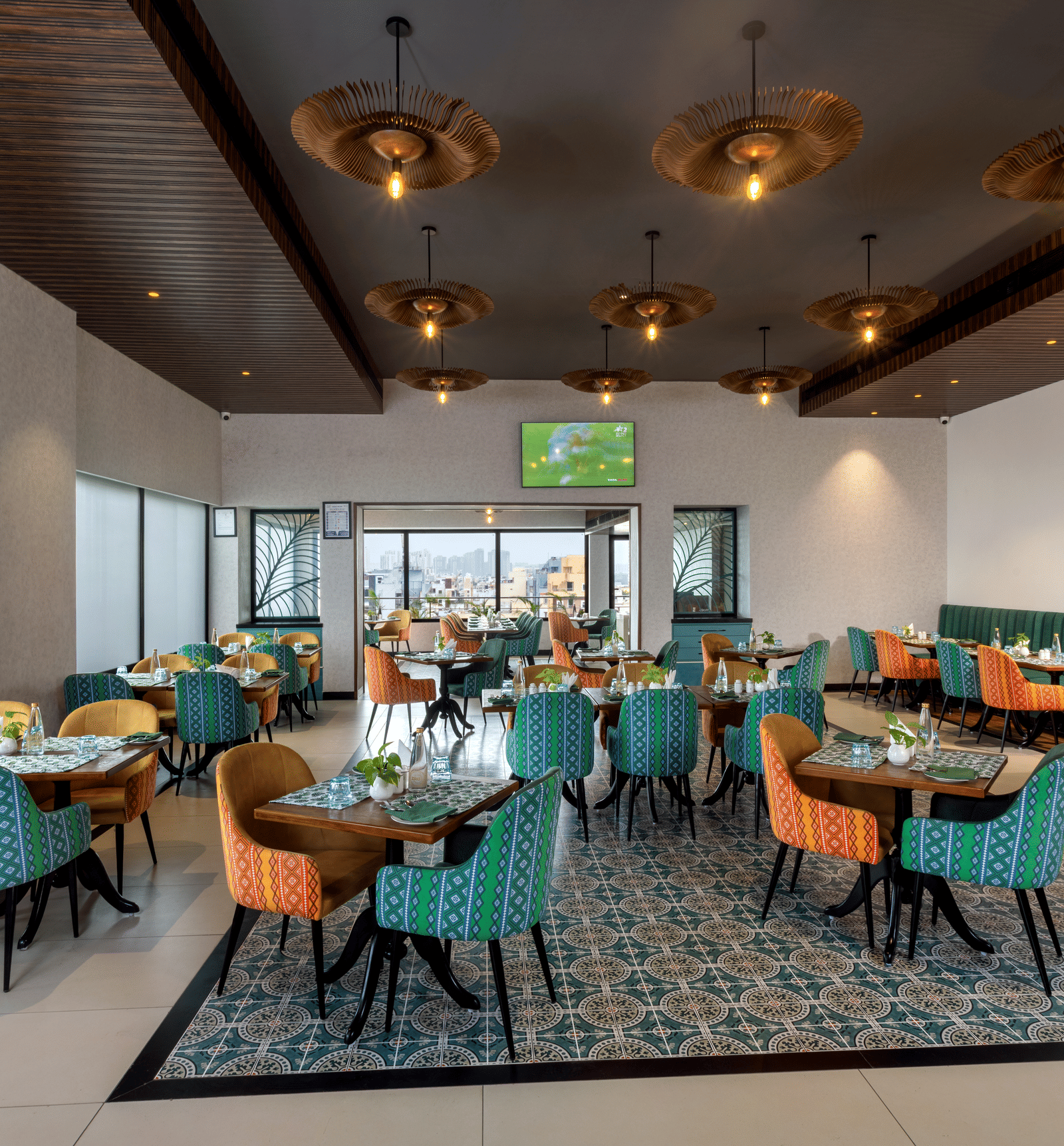 Spacious restaurant at Shalimar in Zibe Luxe Hyderabad by GRT Hotels offering a bright, city-facing setting with stylish ceiling lights - Best Food in Hyderabad