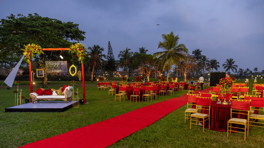 a red pathway with seats on either side - Caravela Beach Resort Goa
