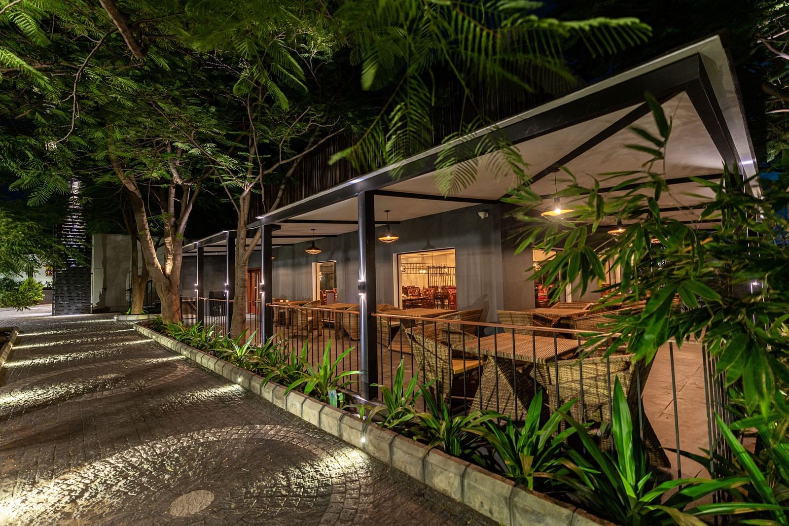 facade image of the mekong restaurant on a late evening along with the stone pathways besides it - Darza Resorts