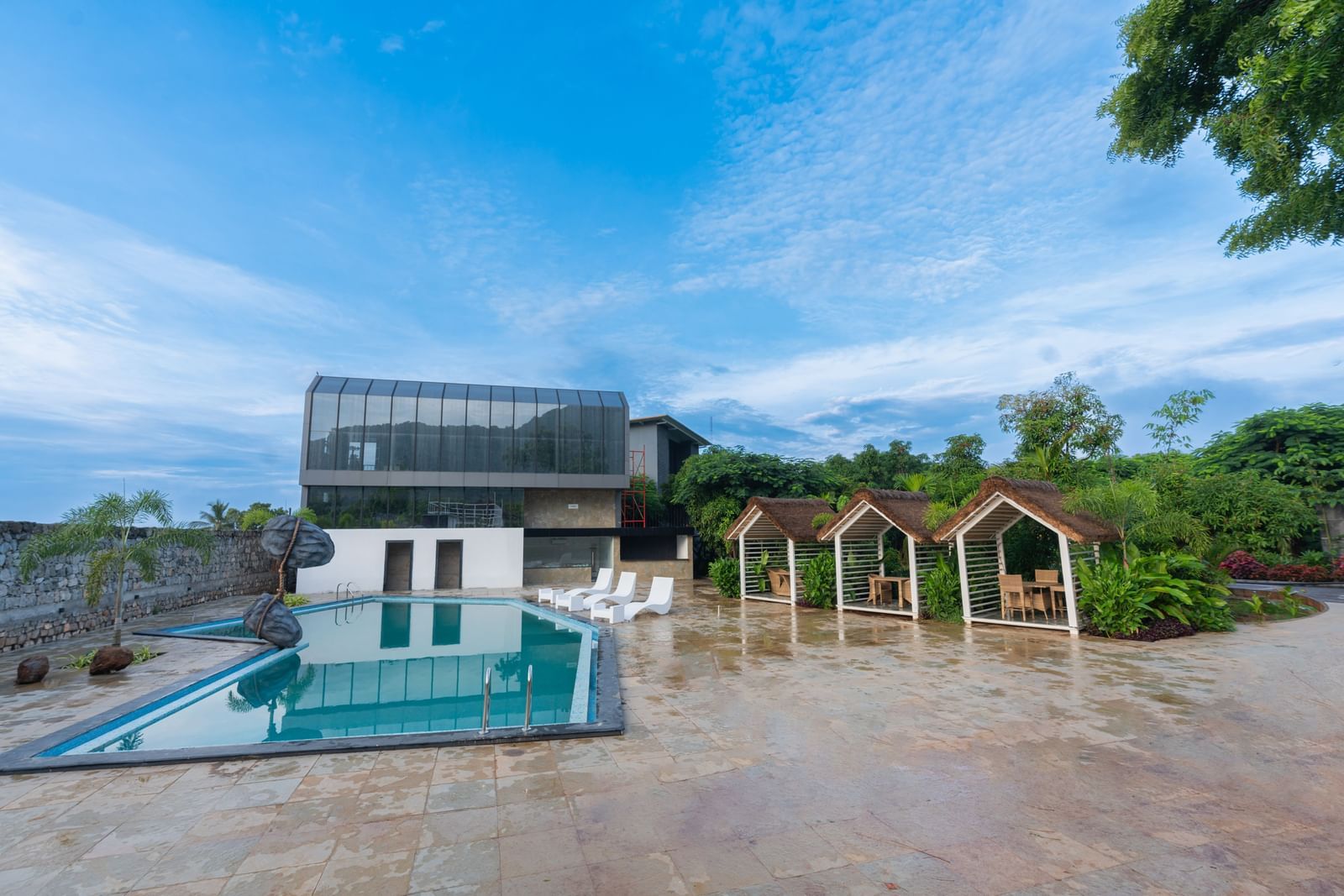 Swimming pool with a complex in the background at Darza Resorts with clear blue sky in the background.