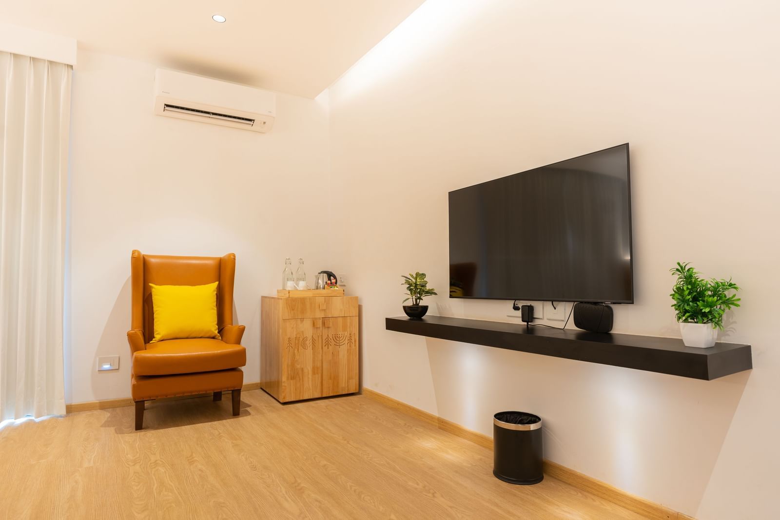 image featuring a wall mounted television along with an arm chair in the corner of the garden room - Darza Resorts