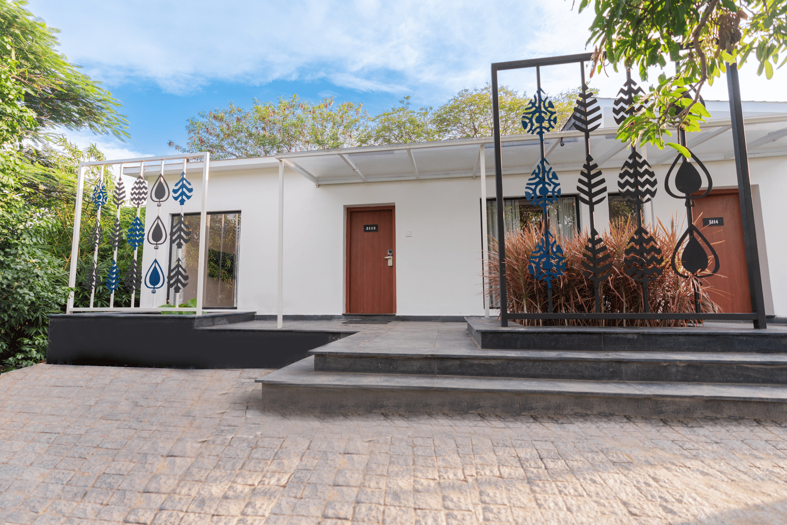 exterior facade of the family villa two bedroom with small steps in front of it - Darza Resorts