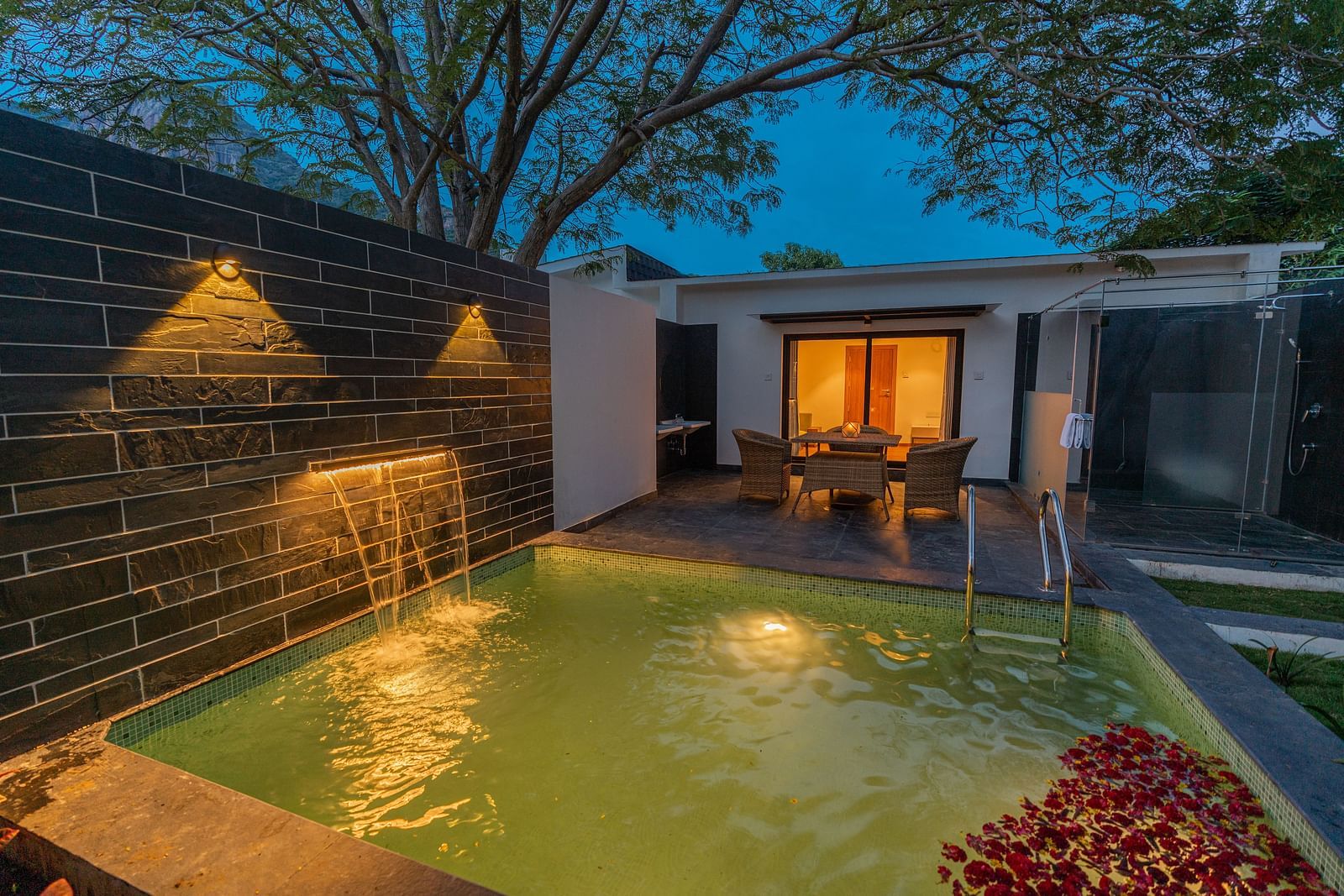 image of the swimming pool in the family villa two bedroom on a late evening with outdoor lights switched on - Darza Resorts