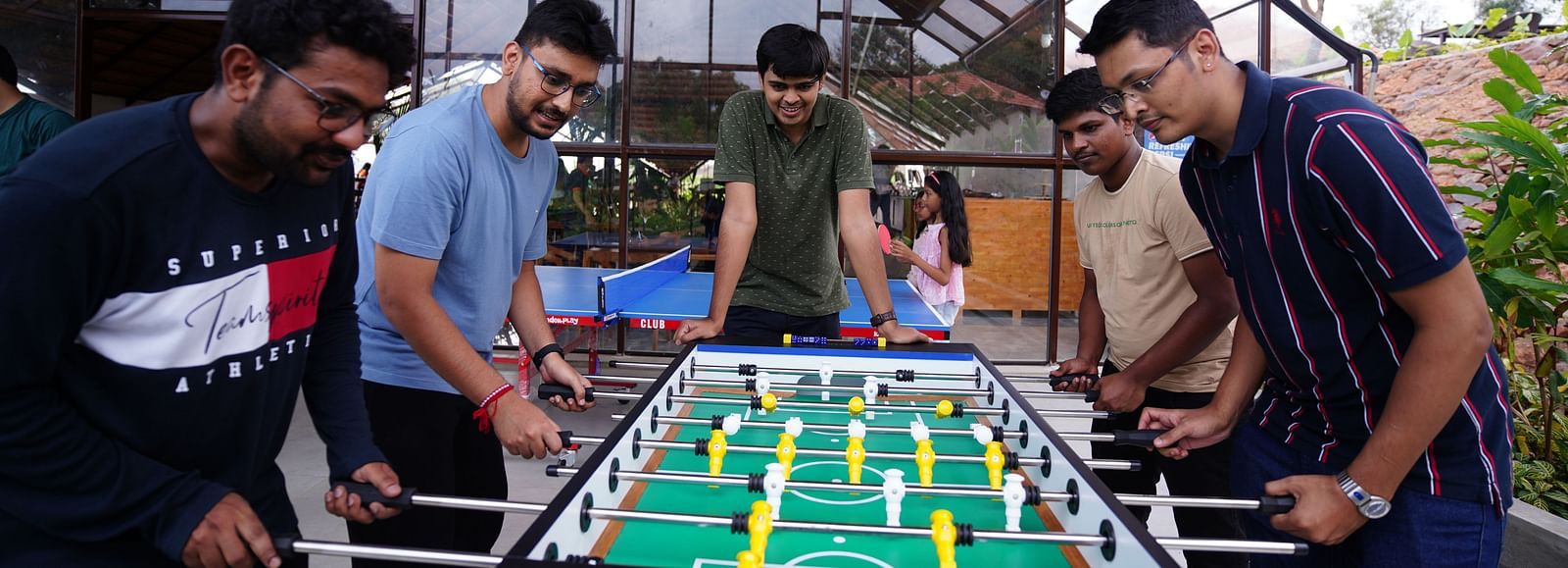 A group of people playing foosball at Ravishing Retreat in Bangalore