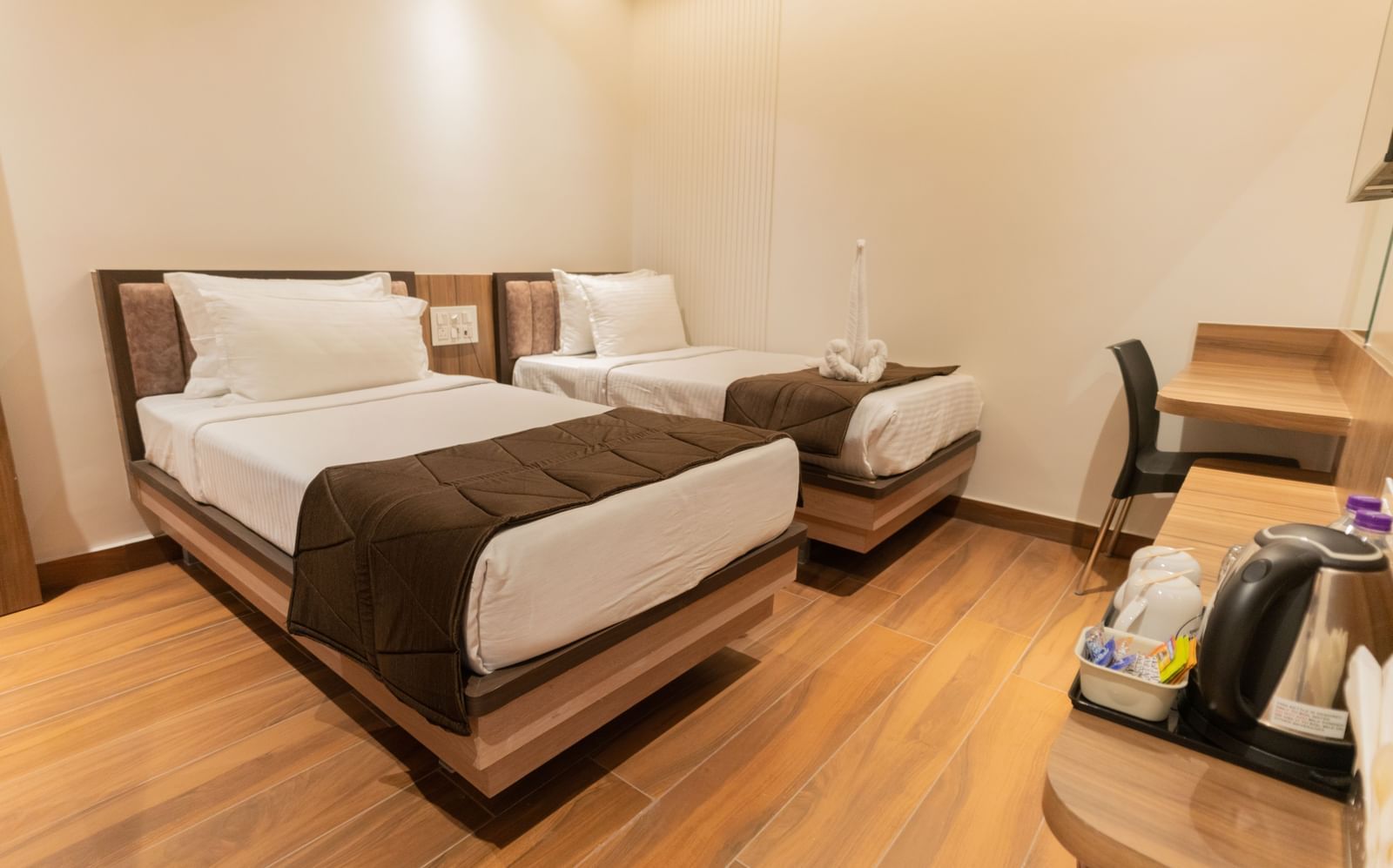 Comfortable twin beds with modern flooring and soft lighting at Beestay Hotels, Rajahmundry.