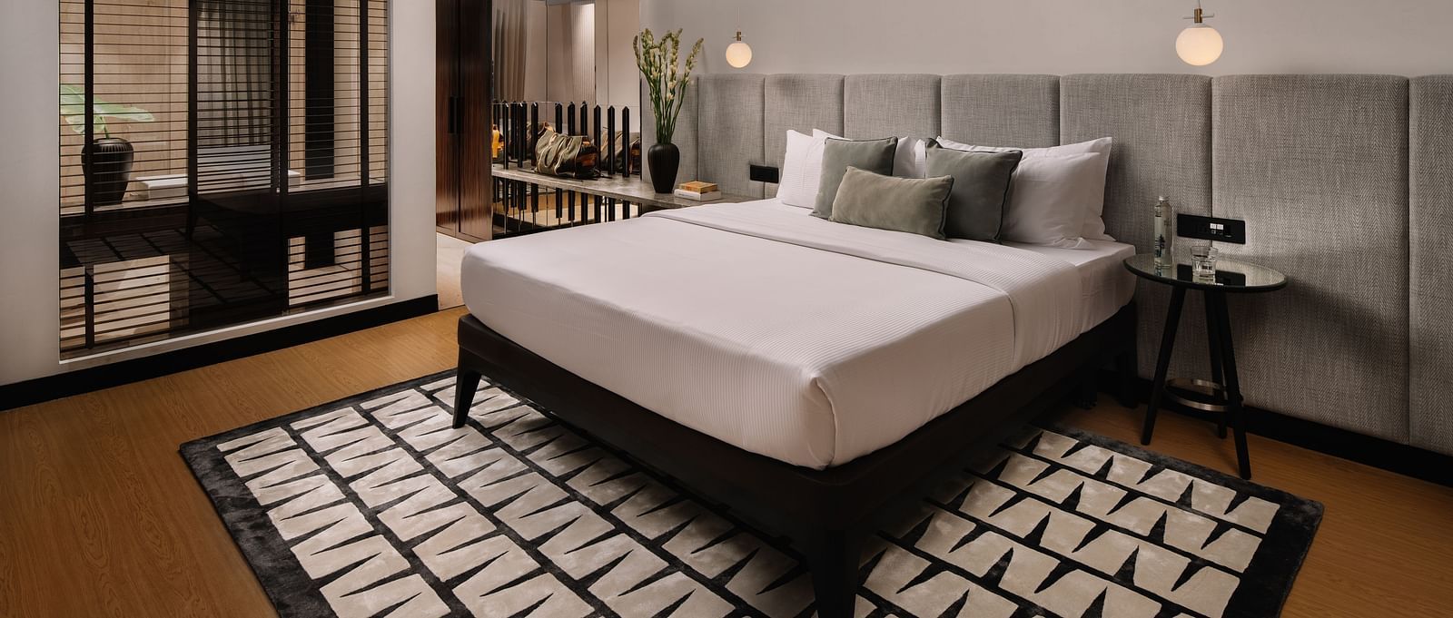 A room with a bed and a carpet below it at The Raintree Hotel, St. Mary's Road.