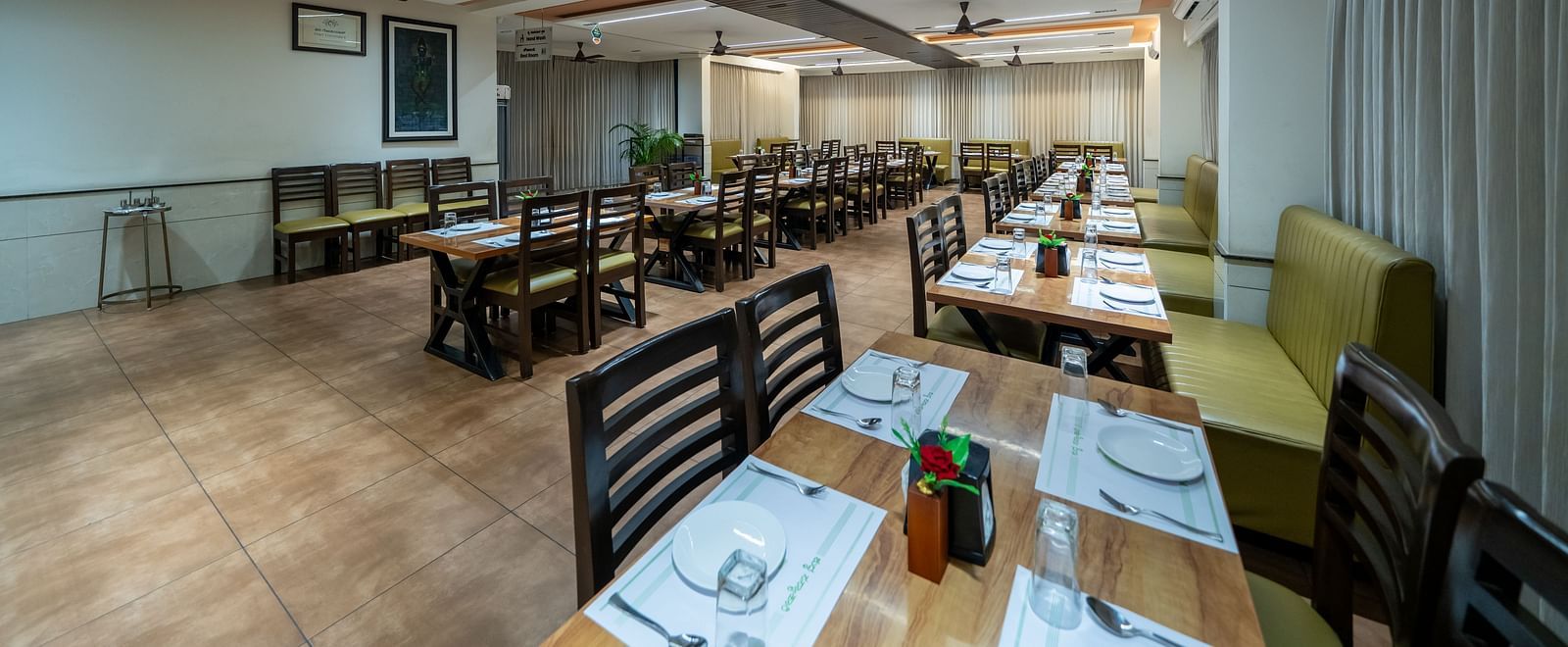 Diagonal view of the dining area at Hari Govinda's, with the table and chairs neatly arranged for the guests