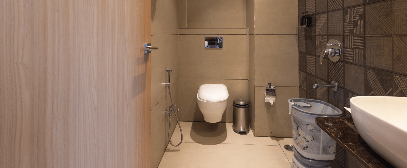 Interior view of a bathroom showing the toilet and the shower area at Pravasa Stay Luv Kush, Indore.