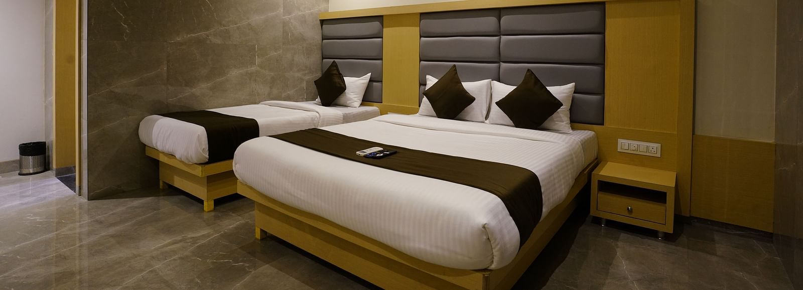 Hotel room with two single beds, dark headboards, and wardrobes - Shyanu Lords Eco Inn Airoli