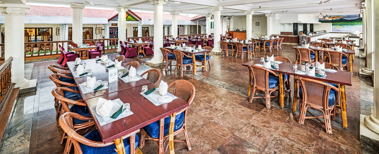 An image of the outdoor dining area featuring tables and chair at GReaT Trails River View Resort Thanjavur By GRT Hotels