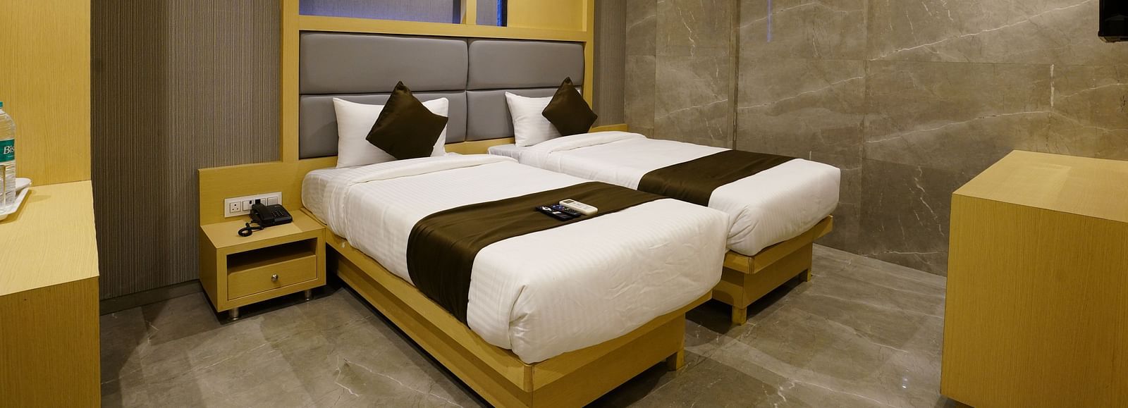 Hotel room with two single beds, bedside tables, and wall shelves - Shyanu Lords Eco Inn Airoli
