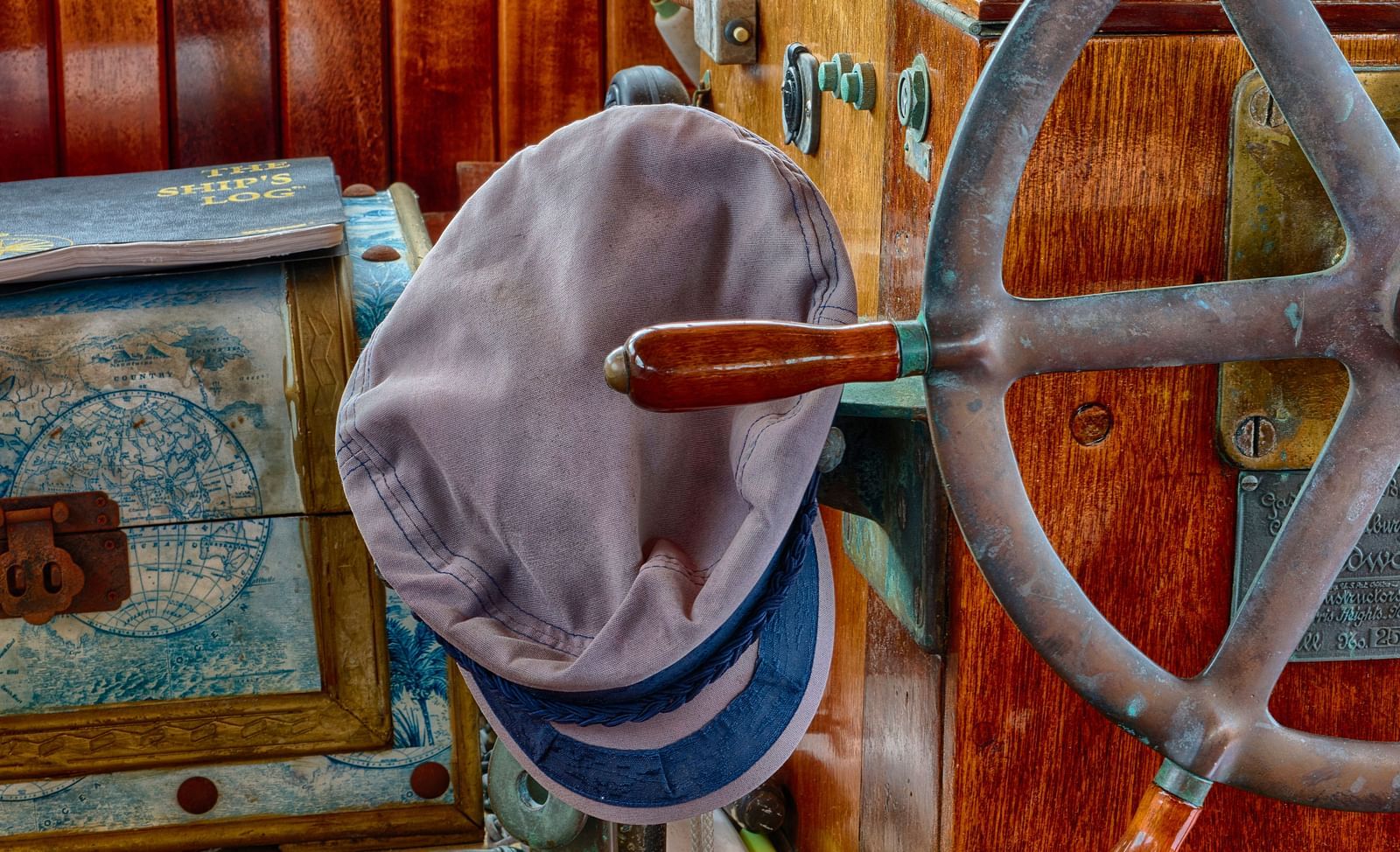 Close-up of a boat’s steering wheel, cap, and equipment at the Casa Morada's dock.