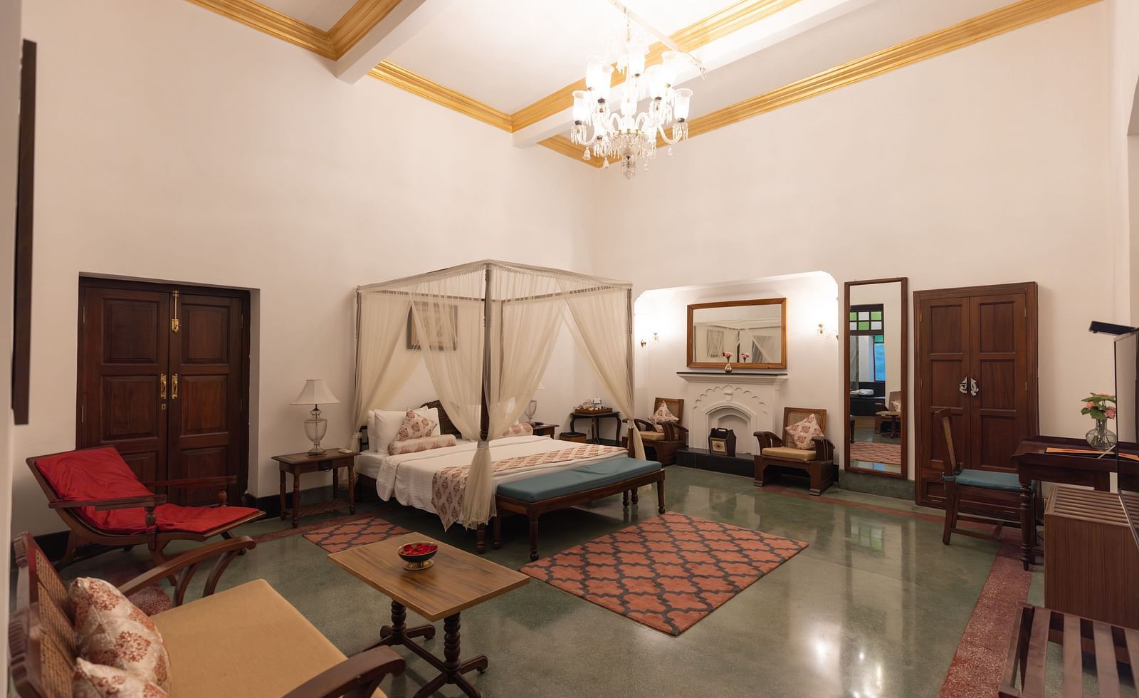 Imperial Suite at Saraca Hotel, Lucknow with a double bed placed in the centre of the room with small carpets placed around it