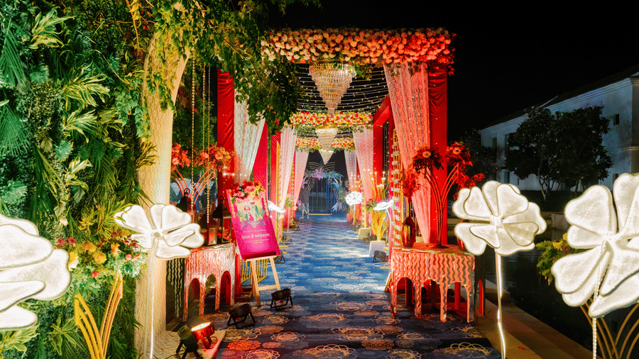 Decorated event entrance at Marasa Sarovar Premiere, Bodhgaya featuring illuminated floral decor, draped fabrics, and a patterned walkway