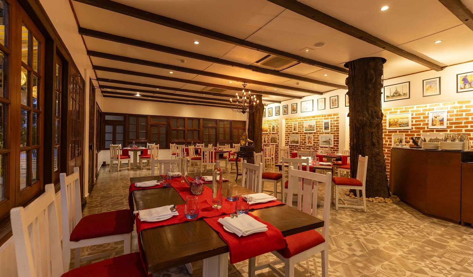 1936 Ristorante at Saraca Hotel, Lucknow with a red and white theme for the seating arrangement and wooden pillars