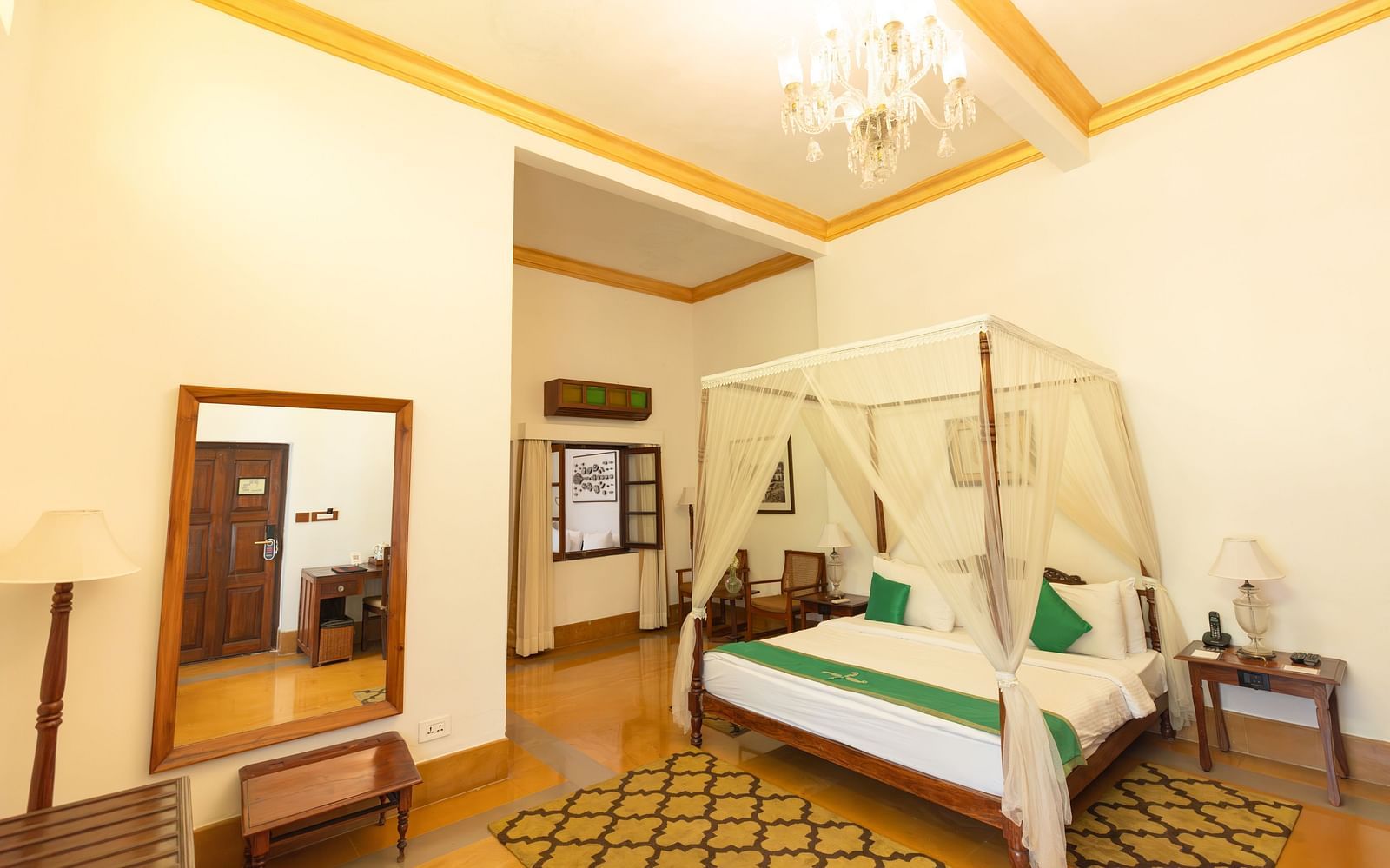 Residency Room of the Famity Suite at Saraca Hotel, Lucknow with  double bed placed in the centre of the room with warm lighting and a yellow ambience