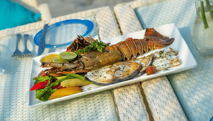 a plate full of sea food kept on a table - Caravela Beach Resort Goa
