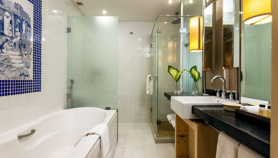 overview of the bathroom with the bathtub in view inside one of the rooms - Caravela Beach Resort Goa