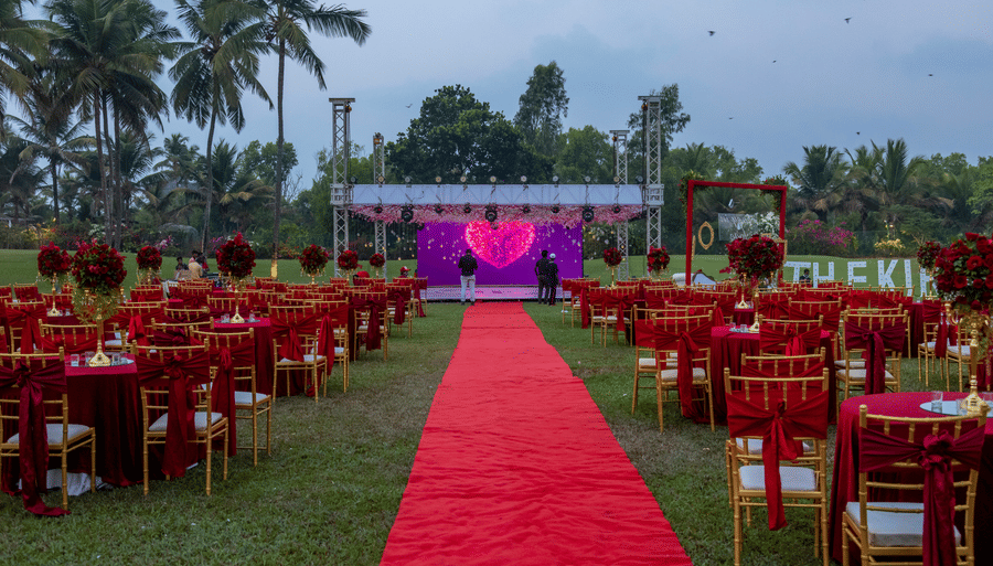 a red pathway with seats on either side - Caravela Beach Resort Goa
