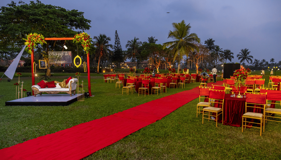 a red pathway with seats on either side - Caravela Beach Resort Goa