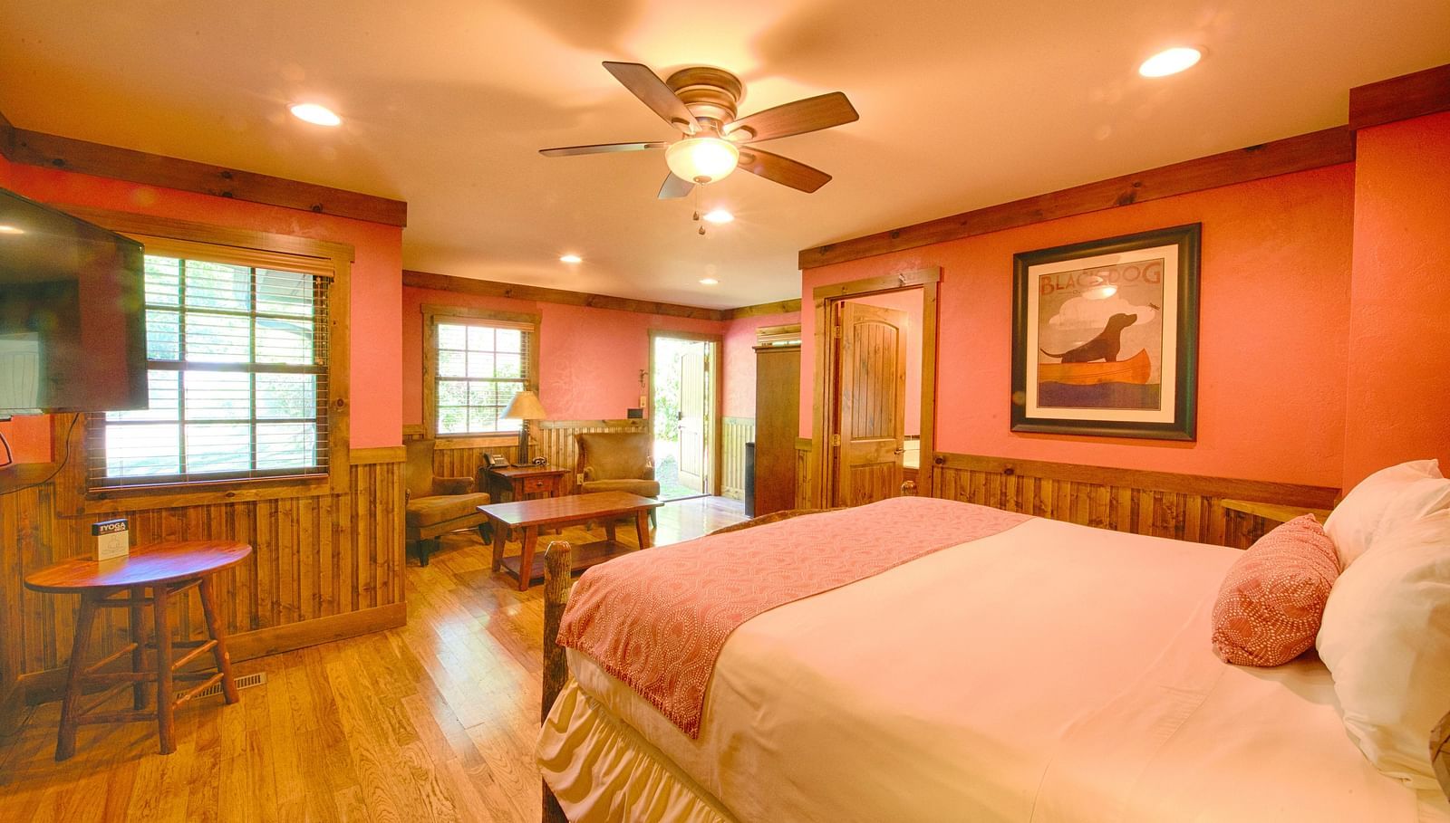 side view image of a room with a double bed featuring a photo frame hanging on the wall - Historic Tapoco Lodge